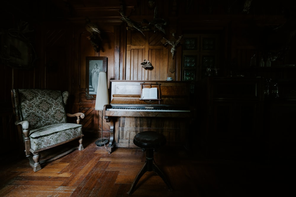 brown wooden upright piano beside brown wooden chair