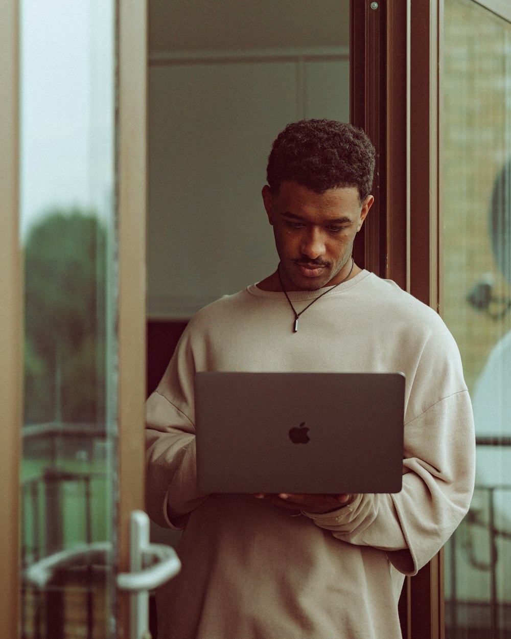 woman in white long sleeve shirt using silver macbook