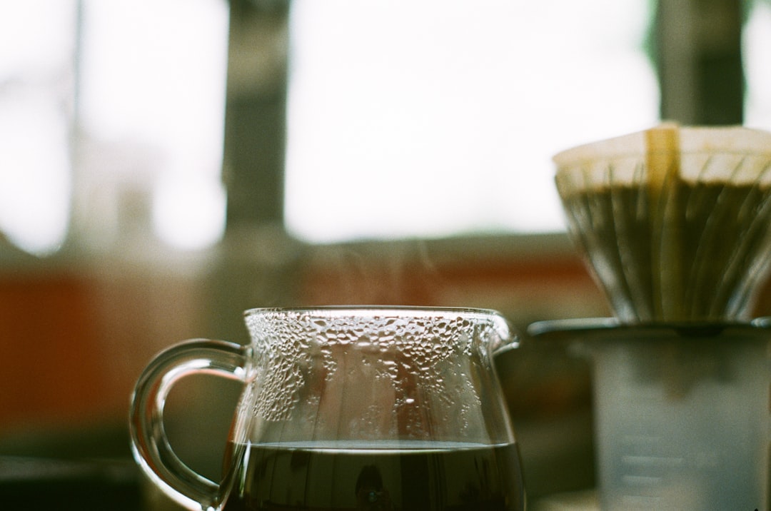 clear glass mug with brown liquid