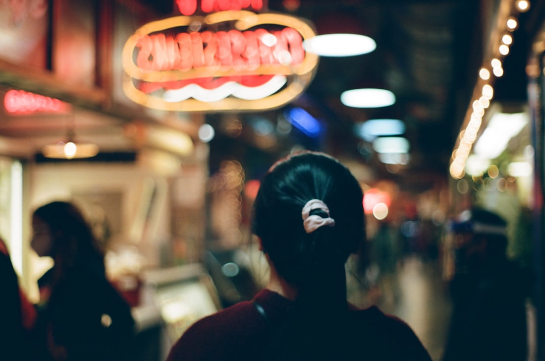 woman in black shirt standing near store