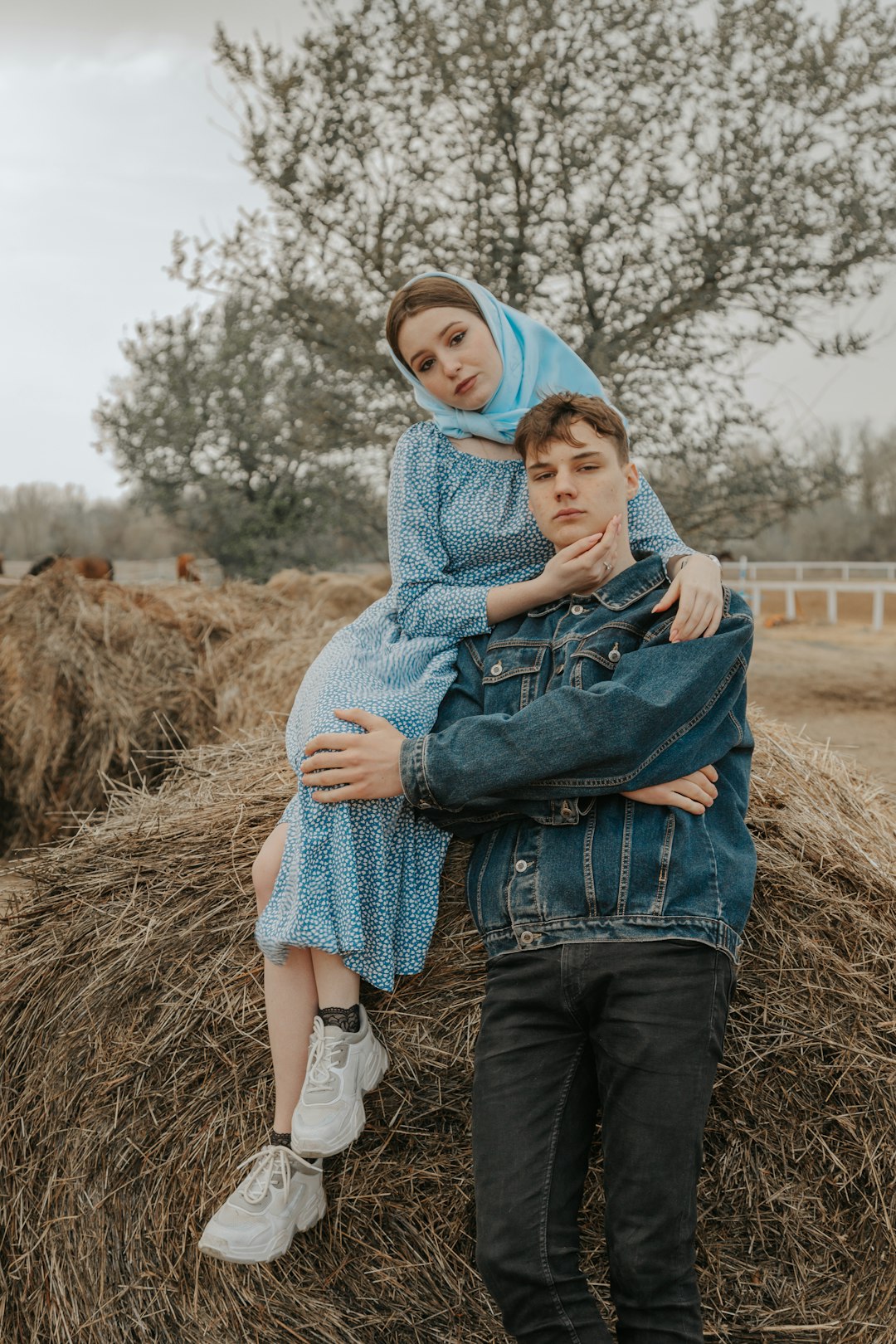 woman in blue hijab carrying baby in blue denim jacket