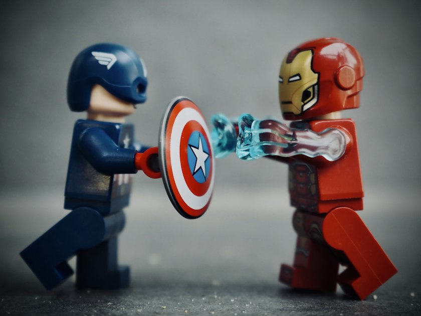 Two toy robots, one red and one blue