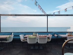 brown wooden table and chairs near swimming pool during daytime