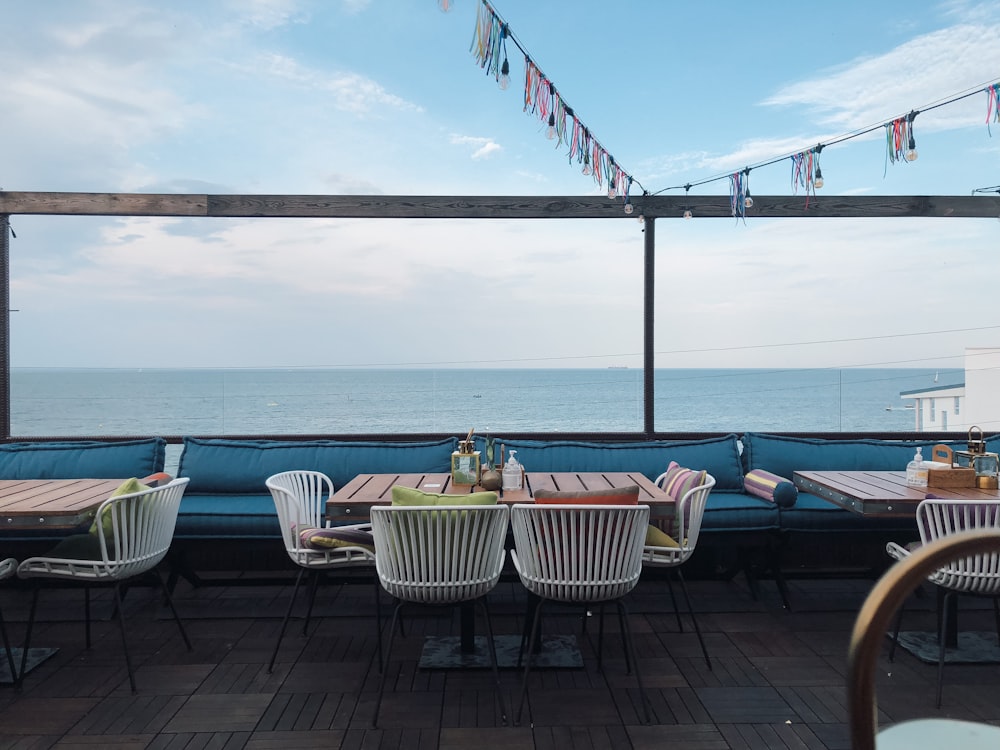 brown wooden table and chairs near swimming pool during daytime