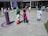 A group of diverse children playing together outdoors in a sunlit park.
