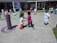 Smiling children wearing colorful casual clothes playing outdoors on a sunny day.