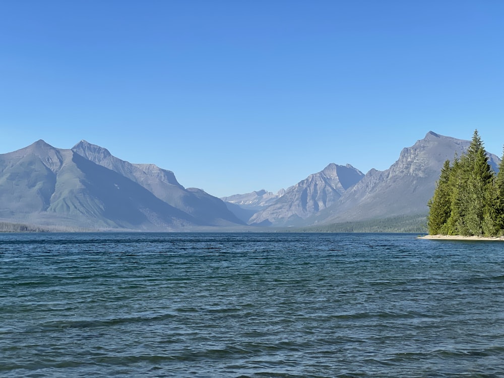 body of water near mountain during daytime