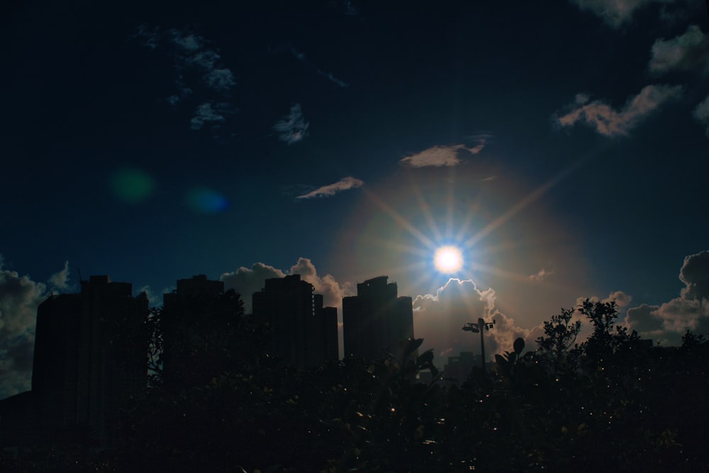 silhouette of city buildings during night time