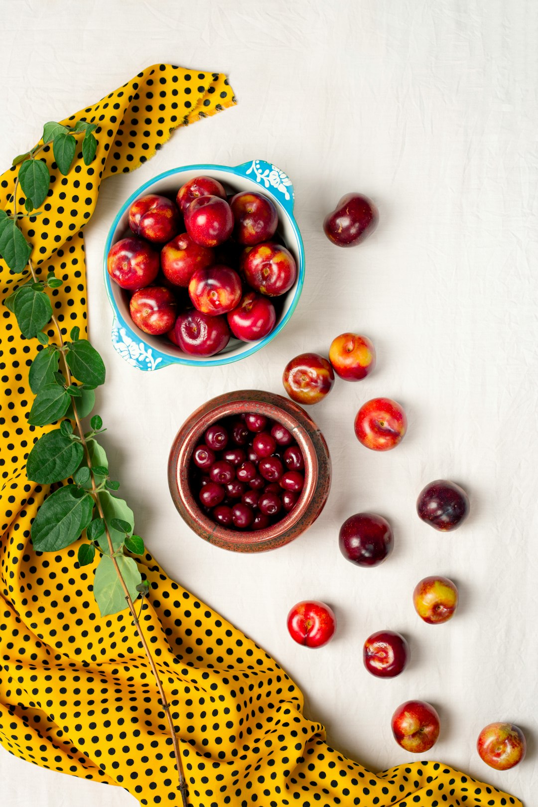 red round fruits on yellow and white polka dot textile