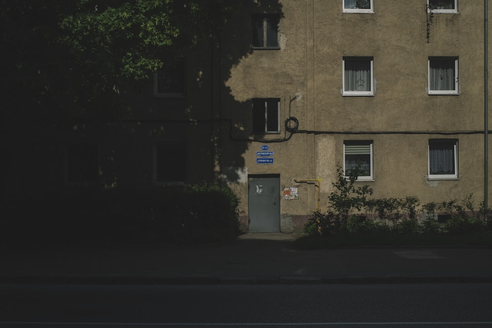 brown concrete building near green trees during daytime