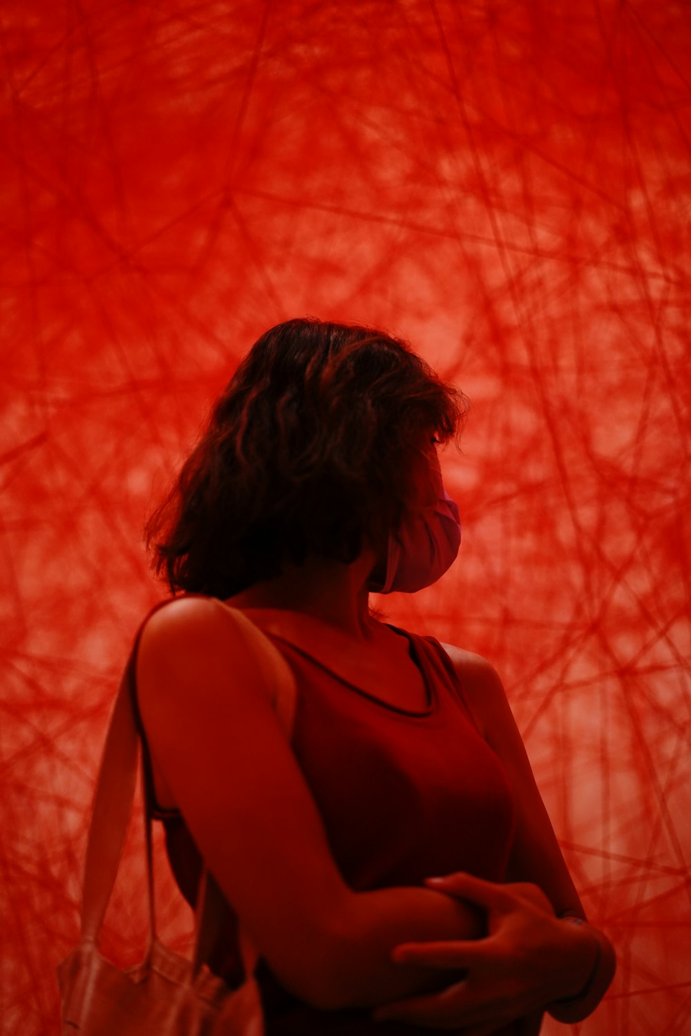 Frau in schwarzem Tanktop steht tagsüber in der Nähe von roten Blattbäumen