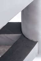 Close-up of a sculptural, geometric concrete architectural element with a smooth, monolithic surface.