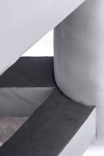 Close-up of refined brutalist concrete architecture with surgical steel accents.