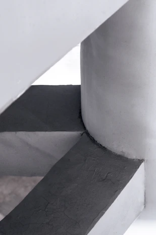 High-resolution photo of a minimalist concrete structure highlighting its hybrid reinforcement details.