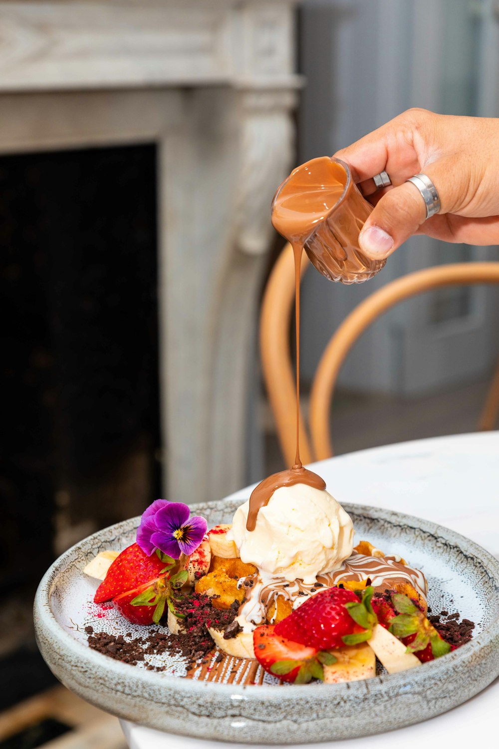 Persona che tiene il gelato sul piatto di ceramica bianca