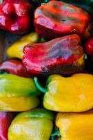 A close-up of colorful bell peppers in a market stall.