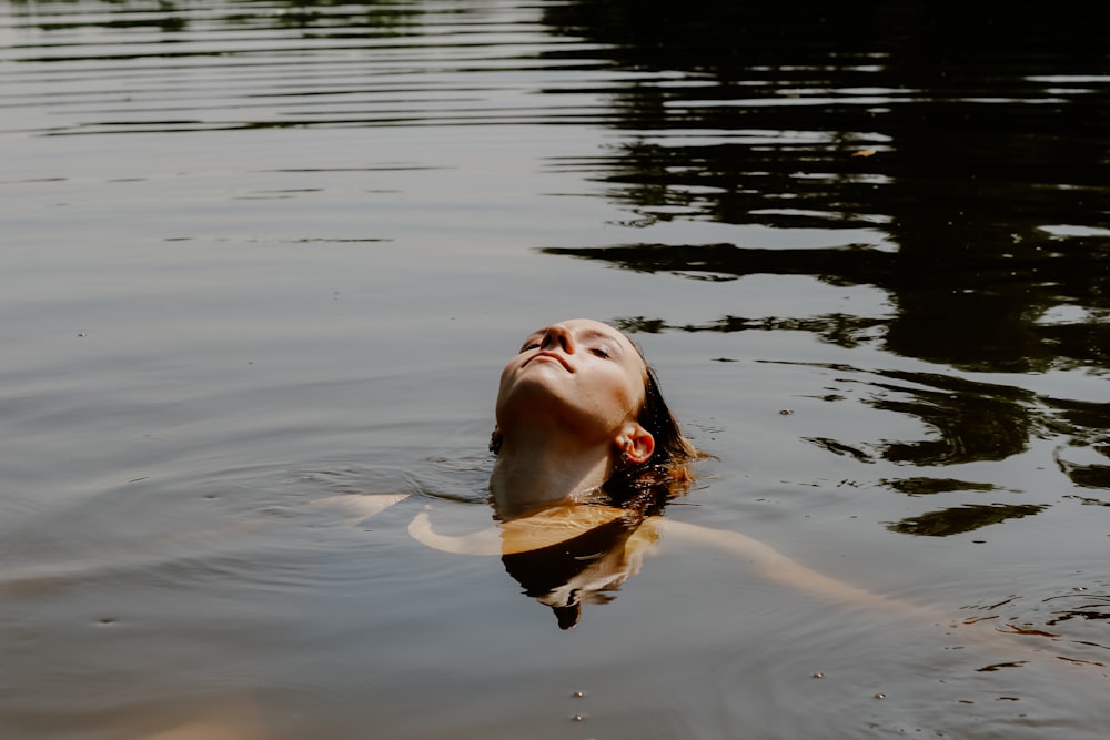 woman in brown shirt on water