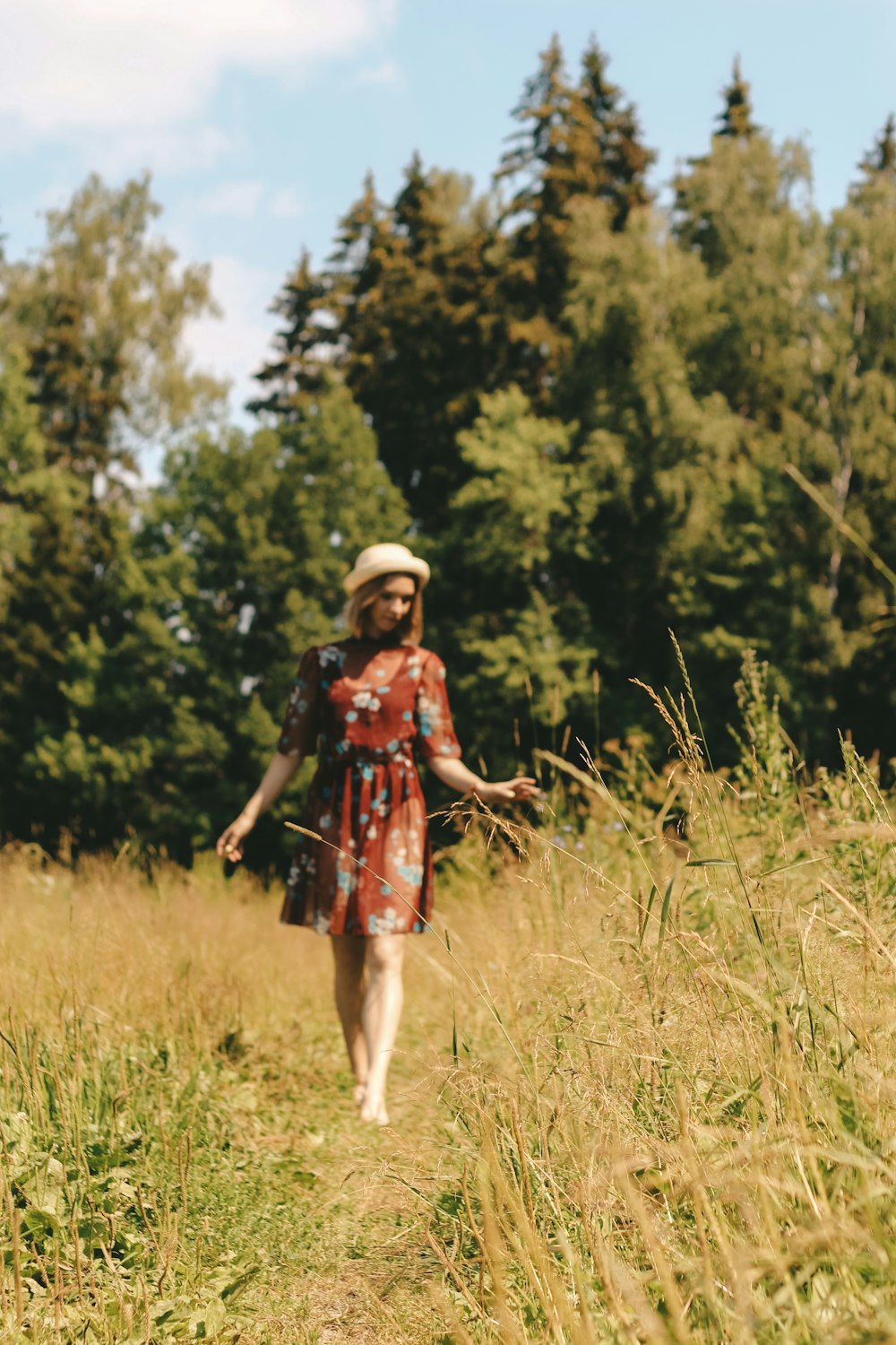 woman in black and red dress standing on green grass field during daytime