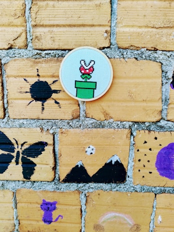 A colorful display of game character designs pinned on a wall.