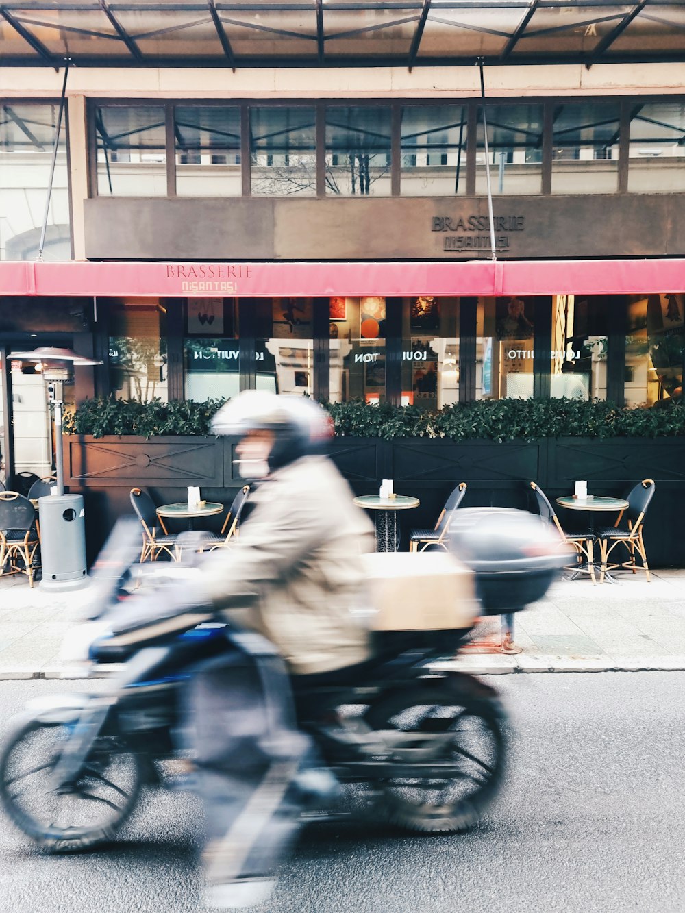 man in gray jacket riding motorcycle