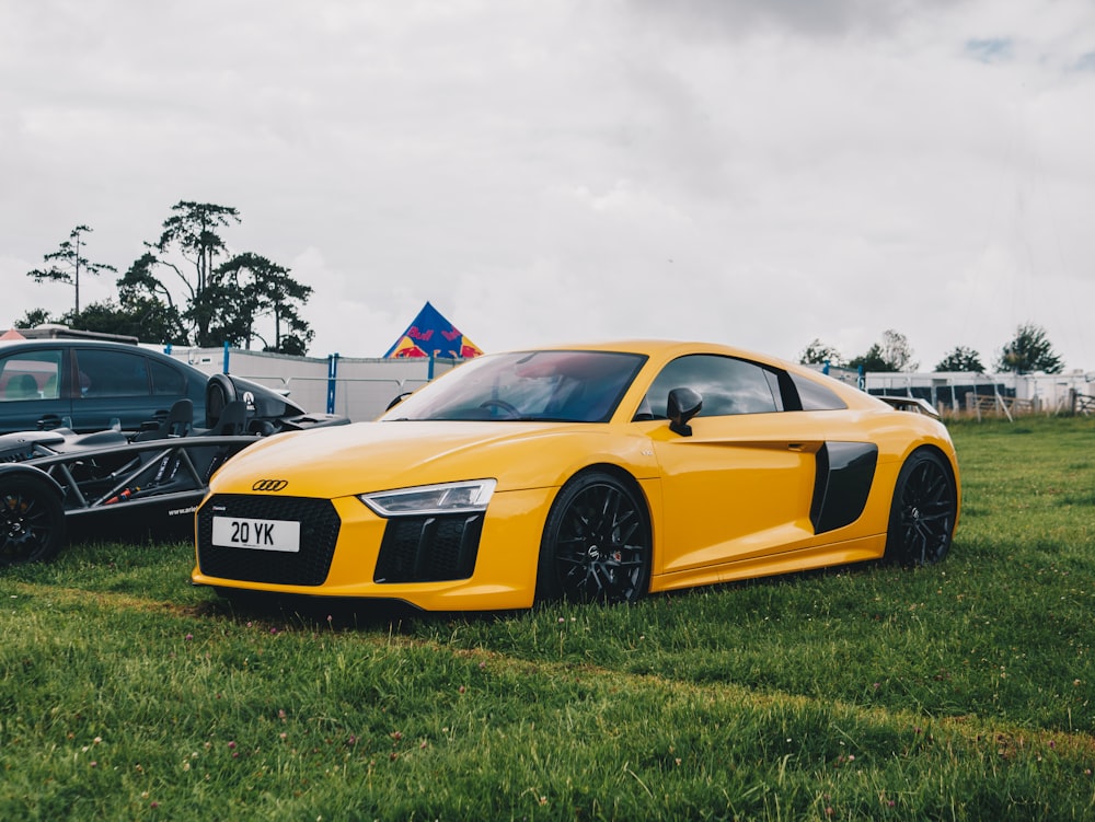 yellow and black lamborghini aventador parked on green grass field during daytime