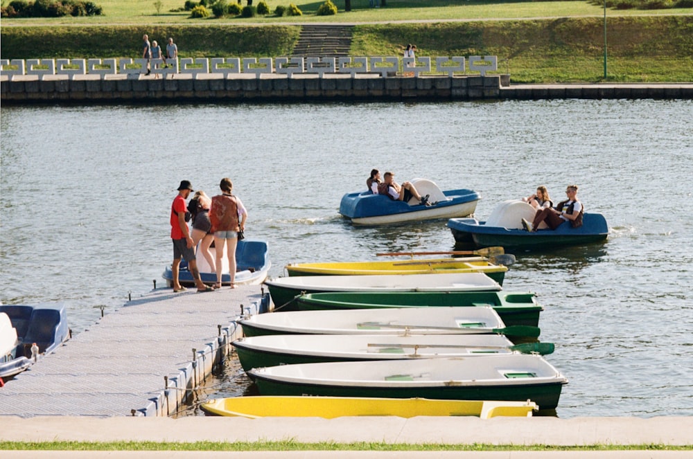 people on white and green boat on body of water during daytime