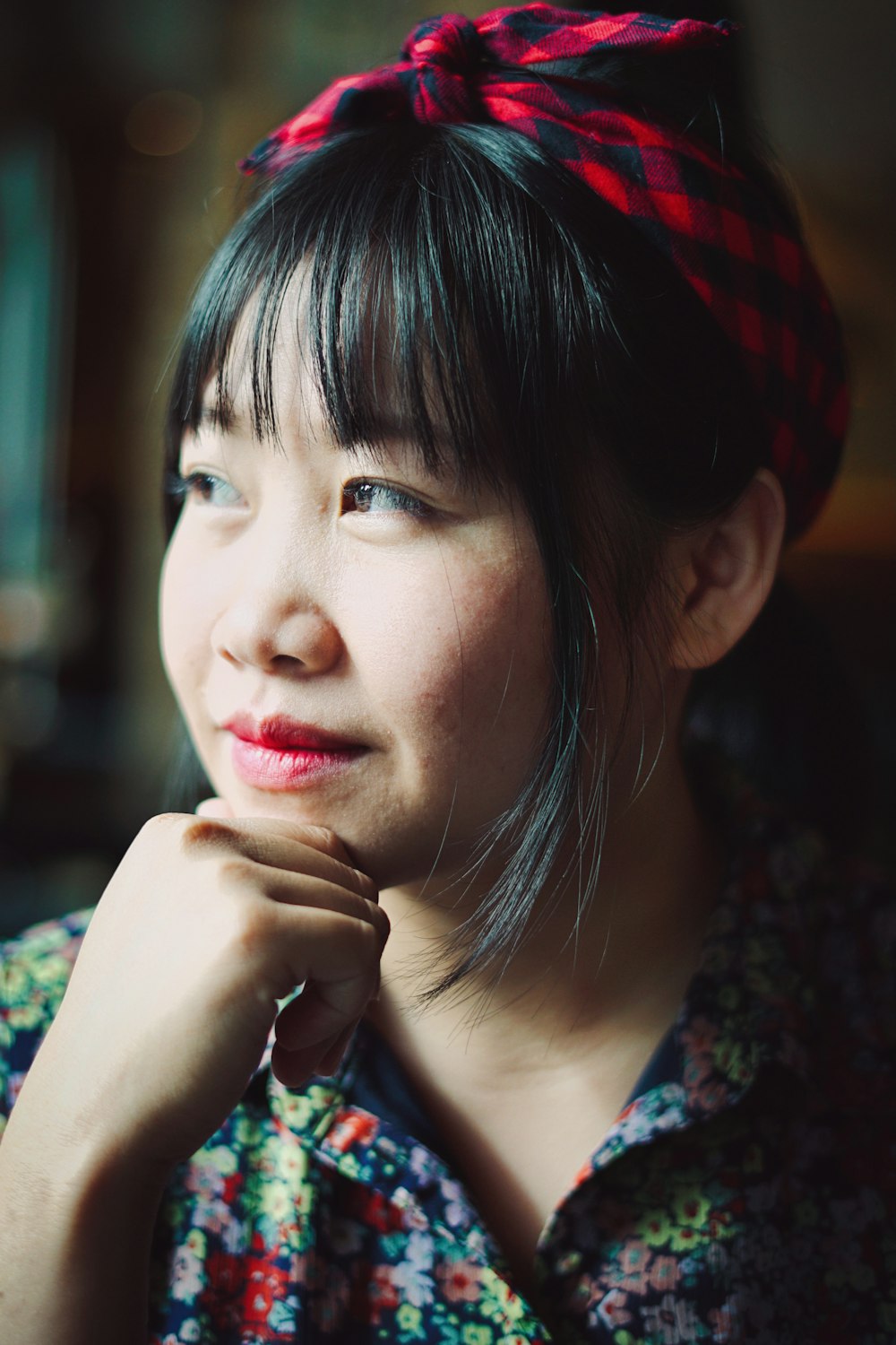 woman in blue and red floral shirt