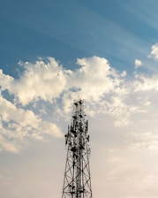 Telecom tower standing tall against a clear sky, symbolizing global connectivity.