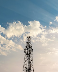 Telecom tower standing tall against a clear sky, symbolizing global connectivity.
