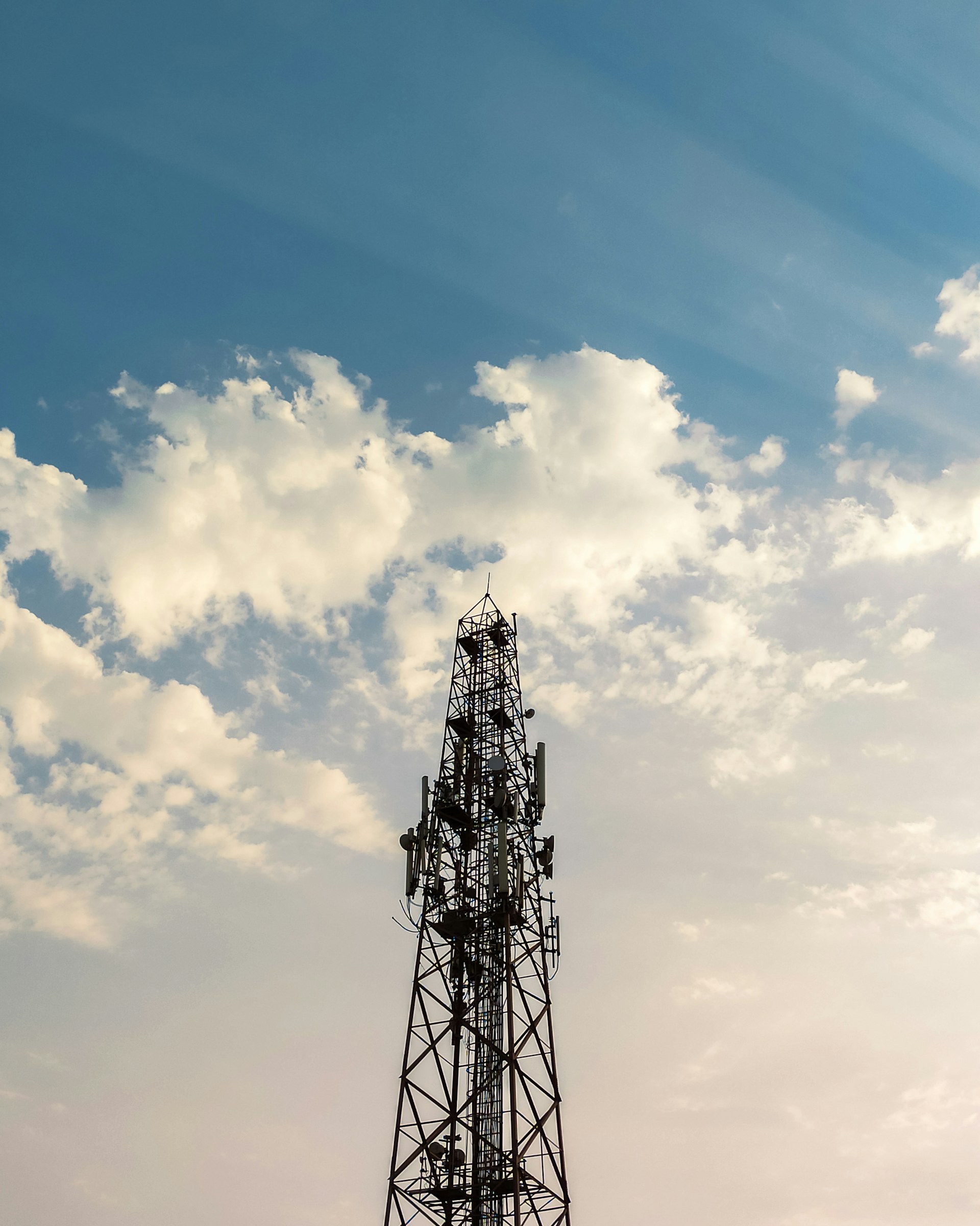 woman wearing yellow long-sleeved dress under white clouds and blue sky during daytime