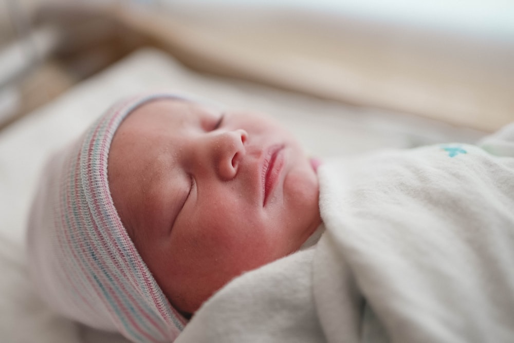 baby in white knit cap