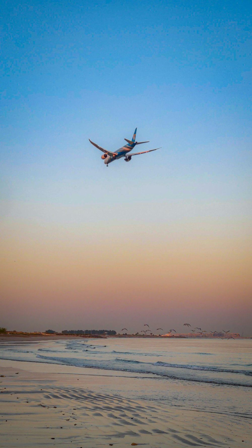 airplane flying over the sea during daytime