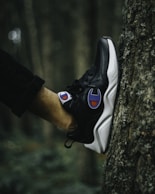 person wearing black and white nike air max 90