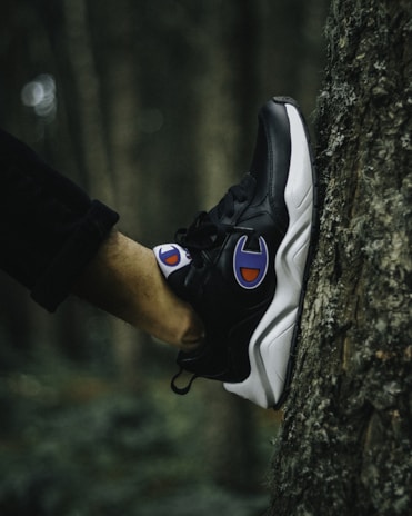 person wearing black and white nike air max 90
