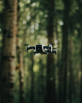 black and gray drone in mid air