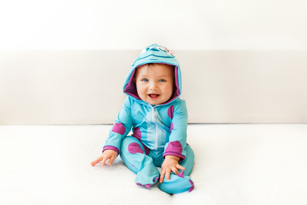 baby in blue and pink hoodie