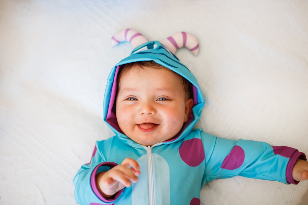 baby in blue and pink hoodie