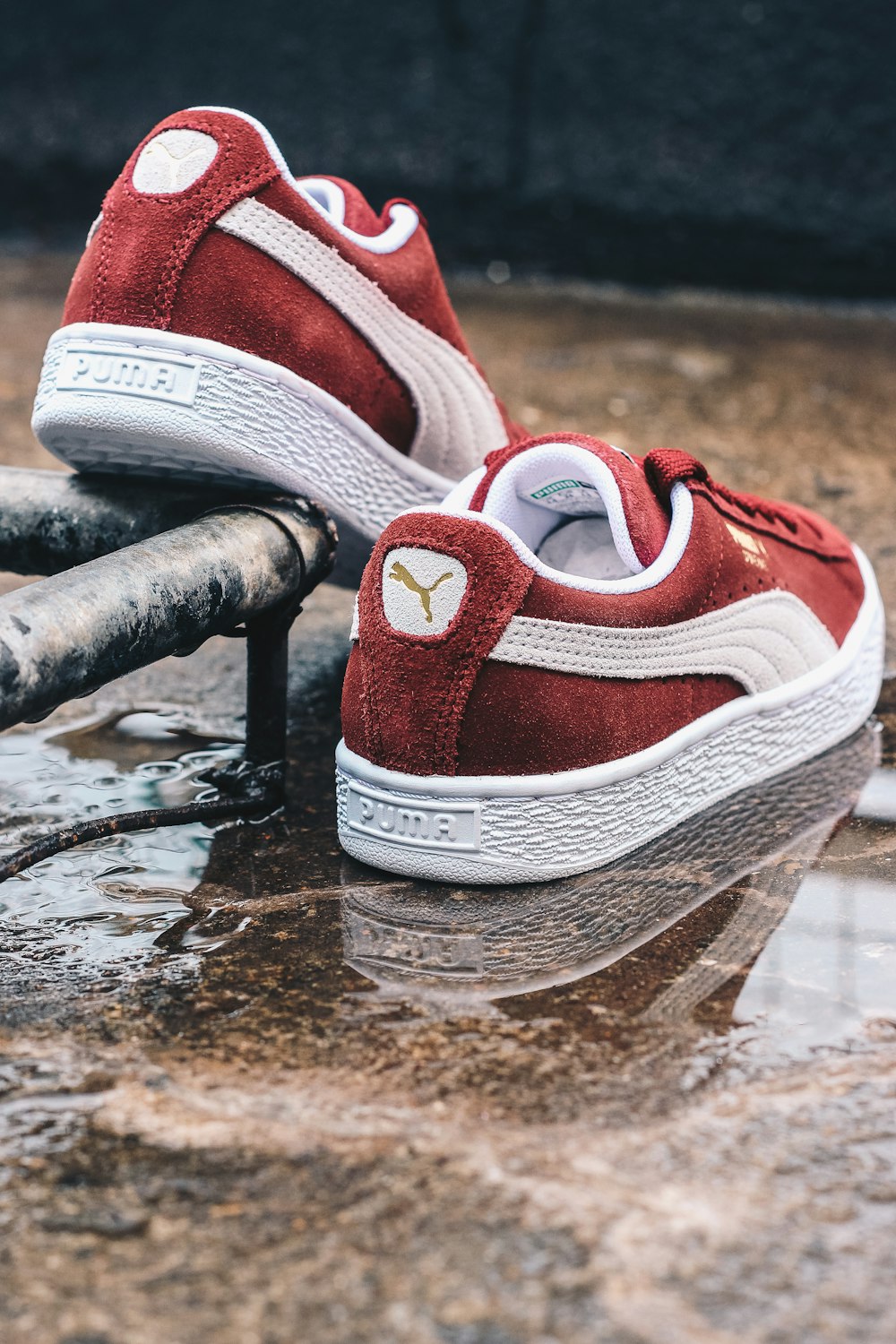Red and white nike athletic shoes on black metal bar photo – Sneakers× sneaker× puma× Image Unsplash
