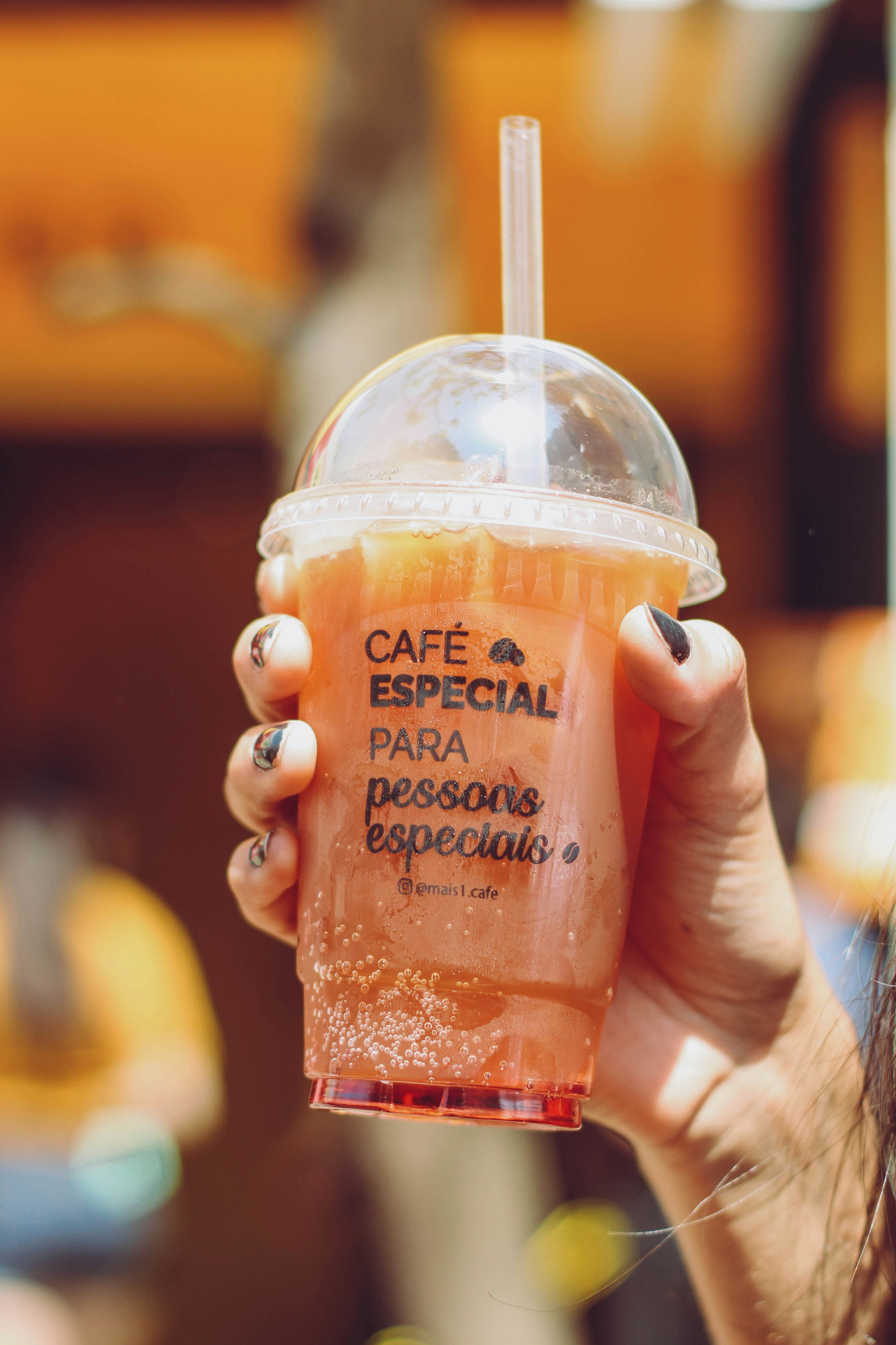 person holding dunkin donuts coffee cup
