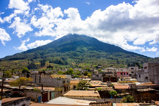 green mountain under white clouds and blue sky during daytime in Santa María de Jesús Guatemala