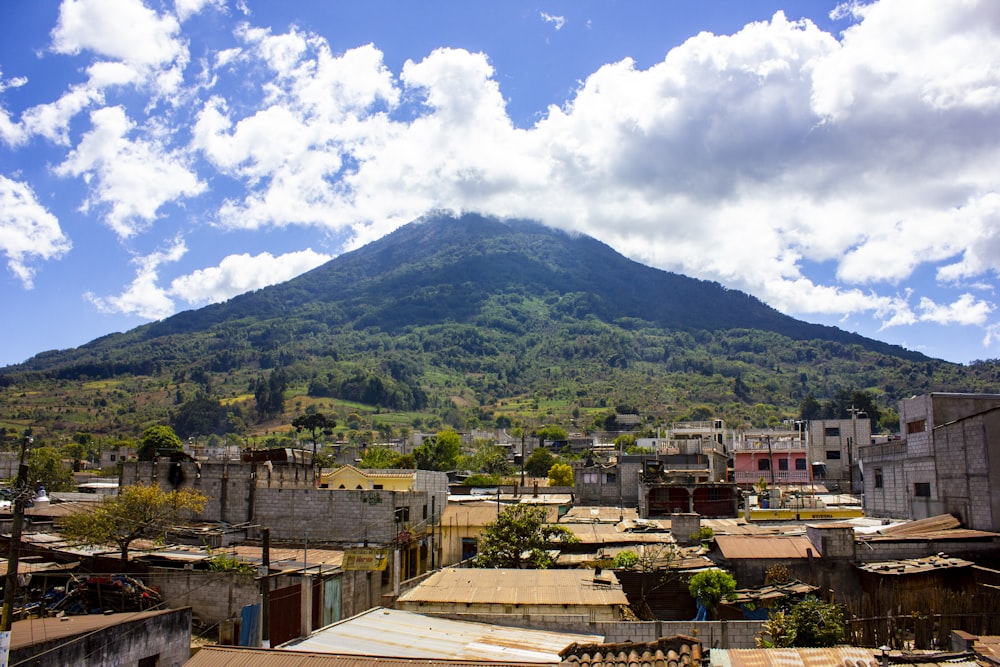 green mountain under white clouds and blue sky during daytime