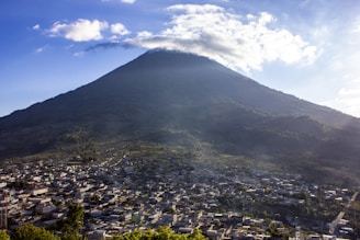 green and white mountain under white clouds during daytime