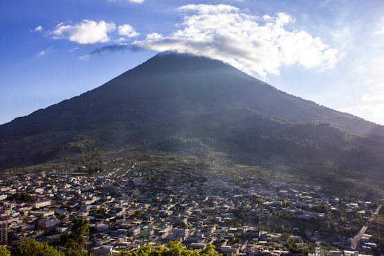 green and white mountain under white clouds during daytime