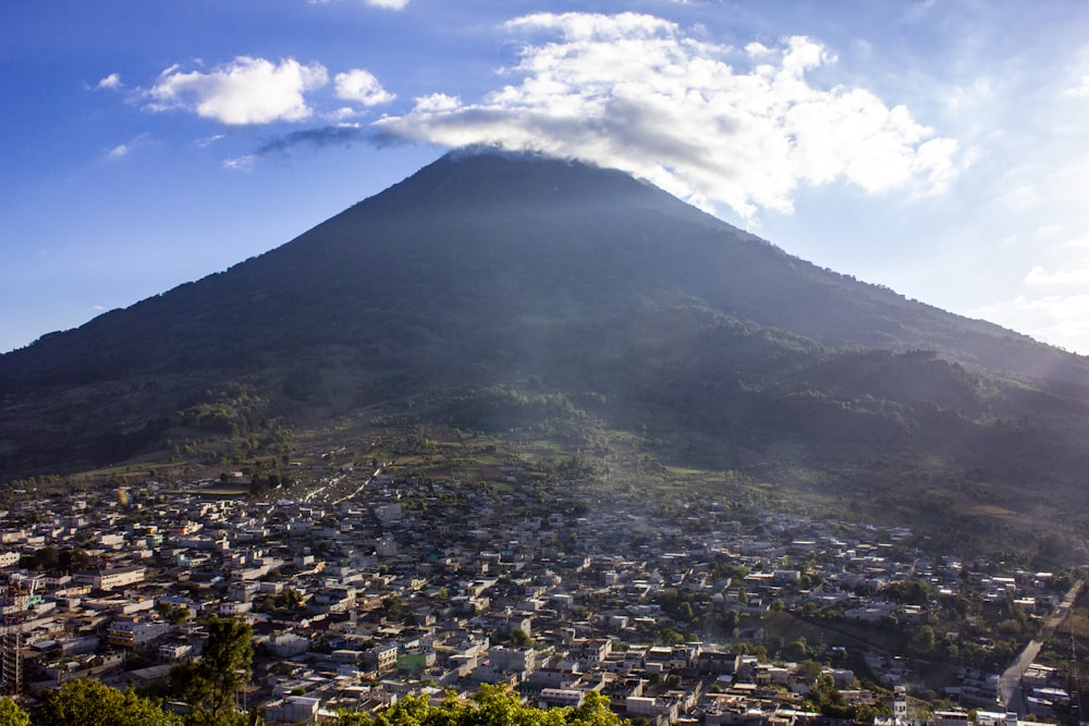 green and white mountain under white clouds during daytime