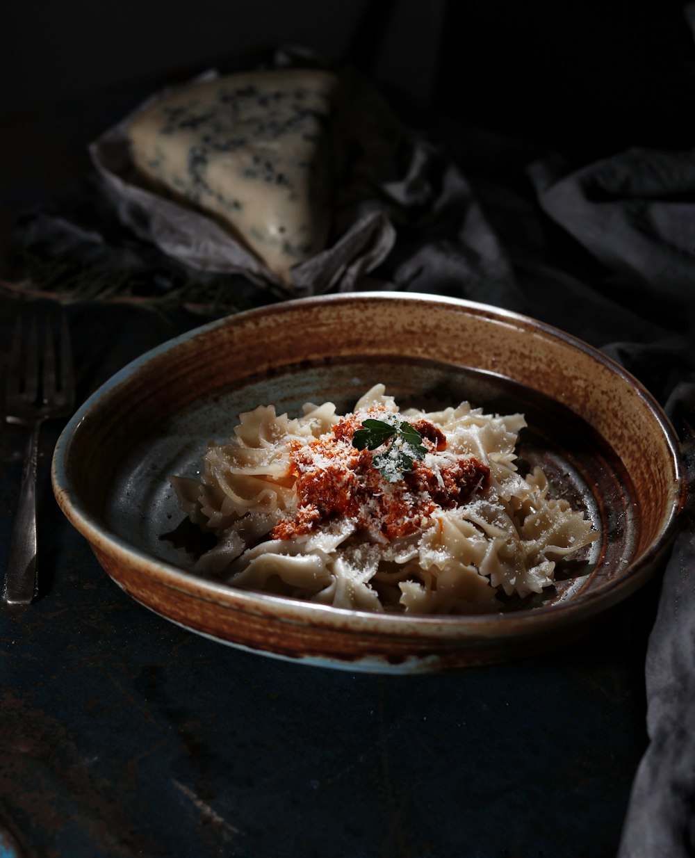 white and brown ceramic bowl with noodles