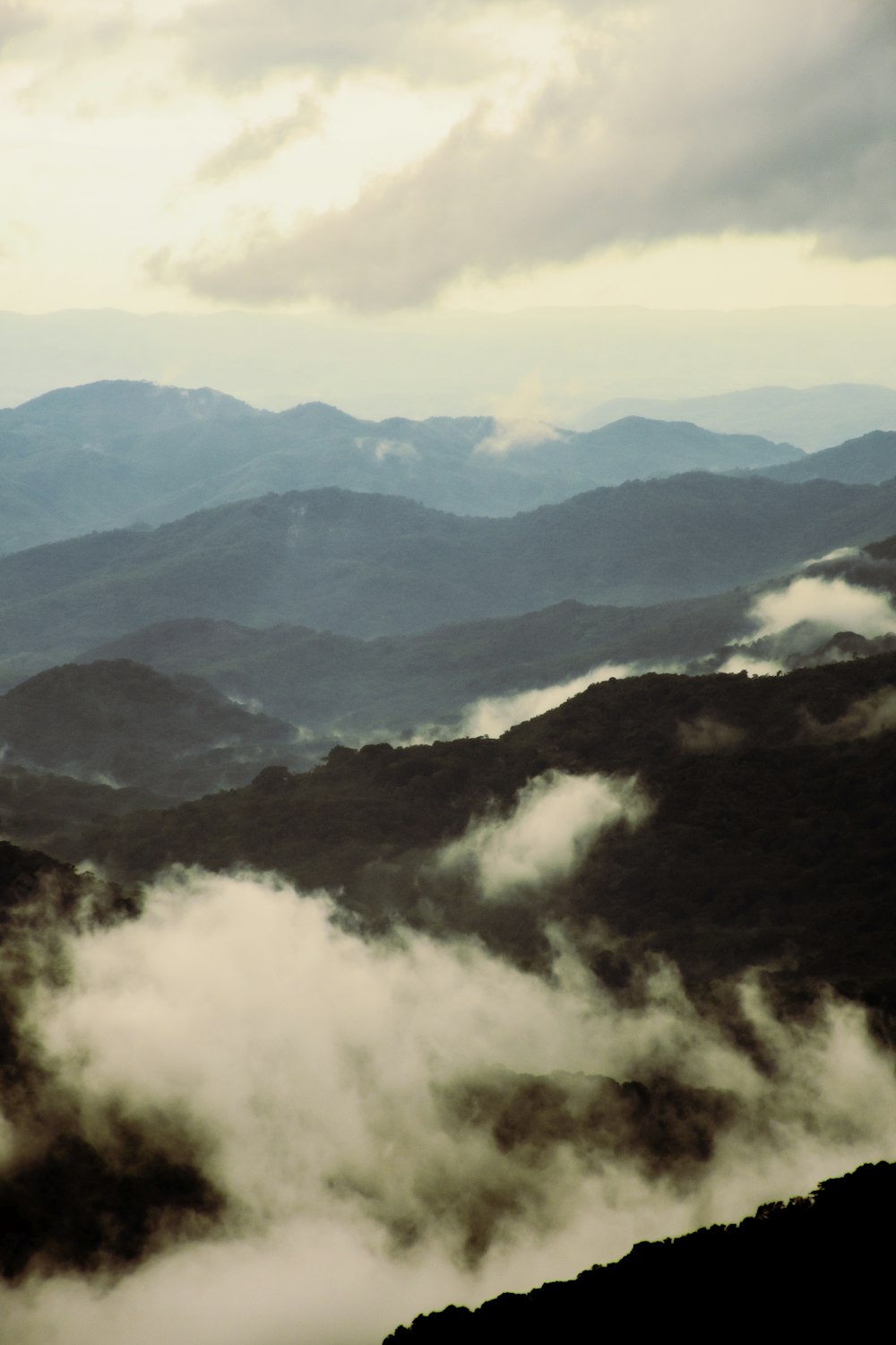 green mountains under white clouds during daytime