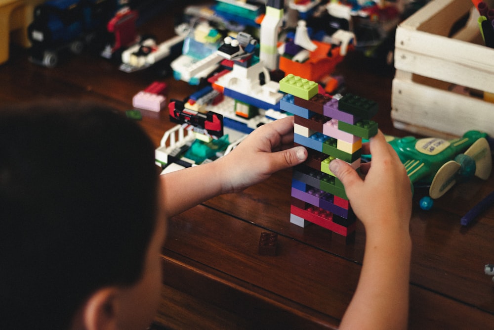 child playing with lego blocks