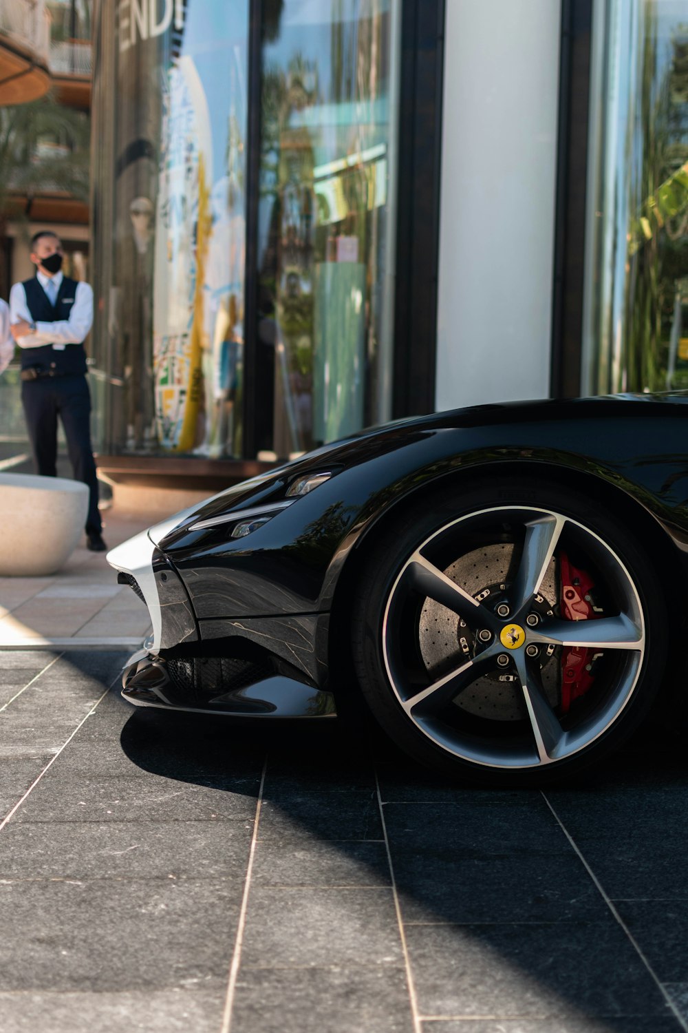 black car parked near woman in white dress