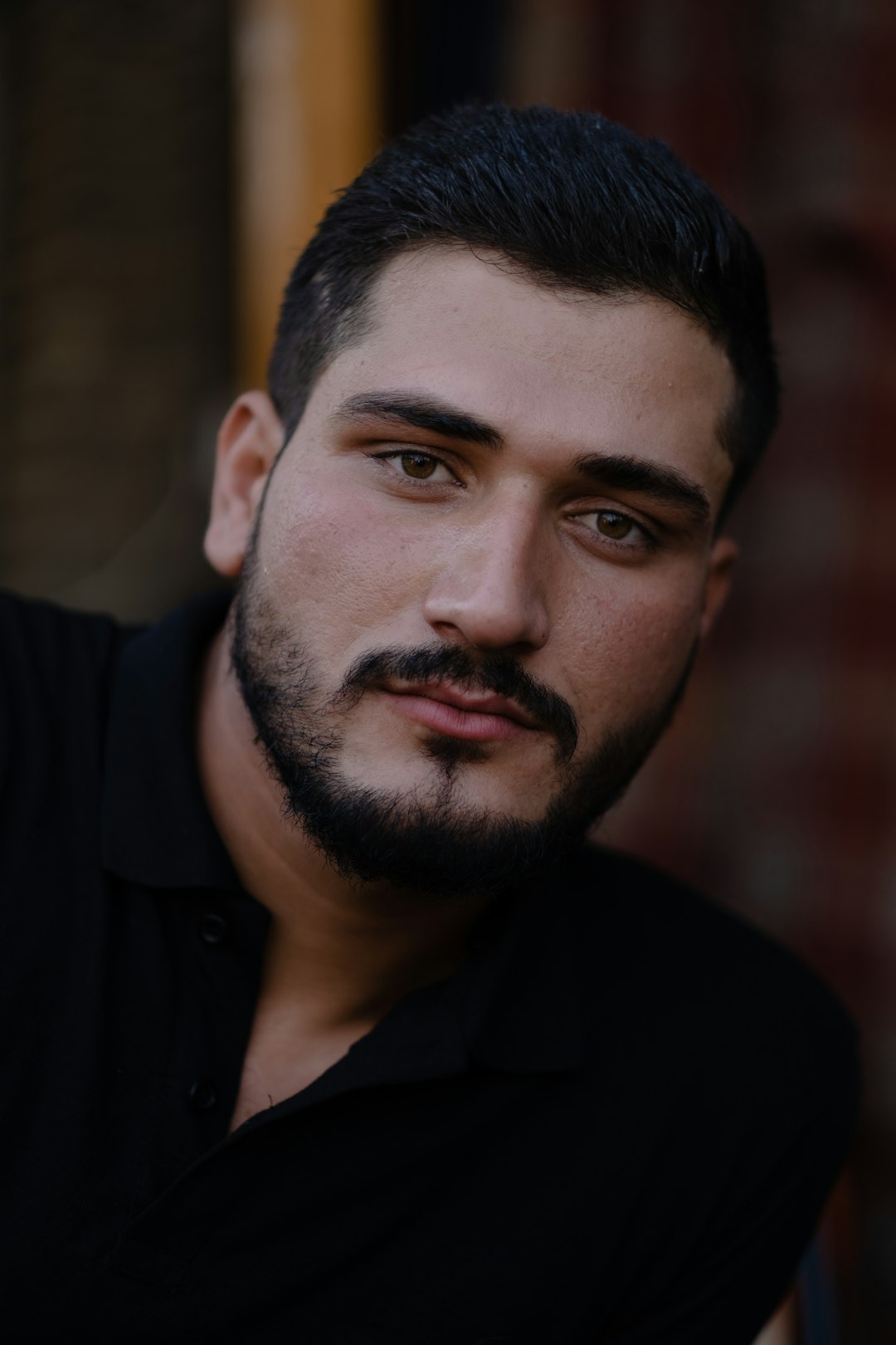 man in black collared shirt