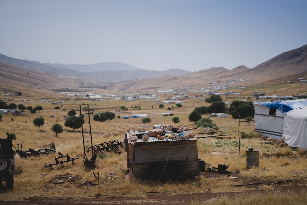 brown wooden house on brown field during daytime